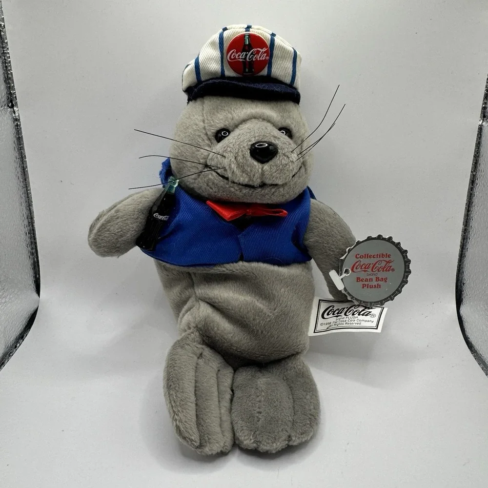 Coca-Cola collectible bean‎ bag plush seal from 1998, wearing a delivery outfit
